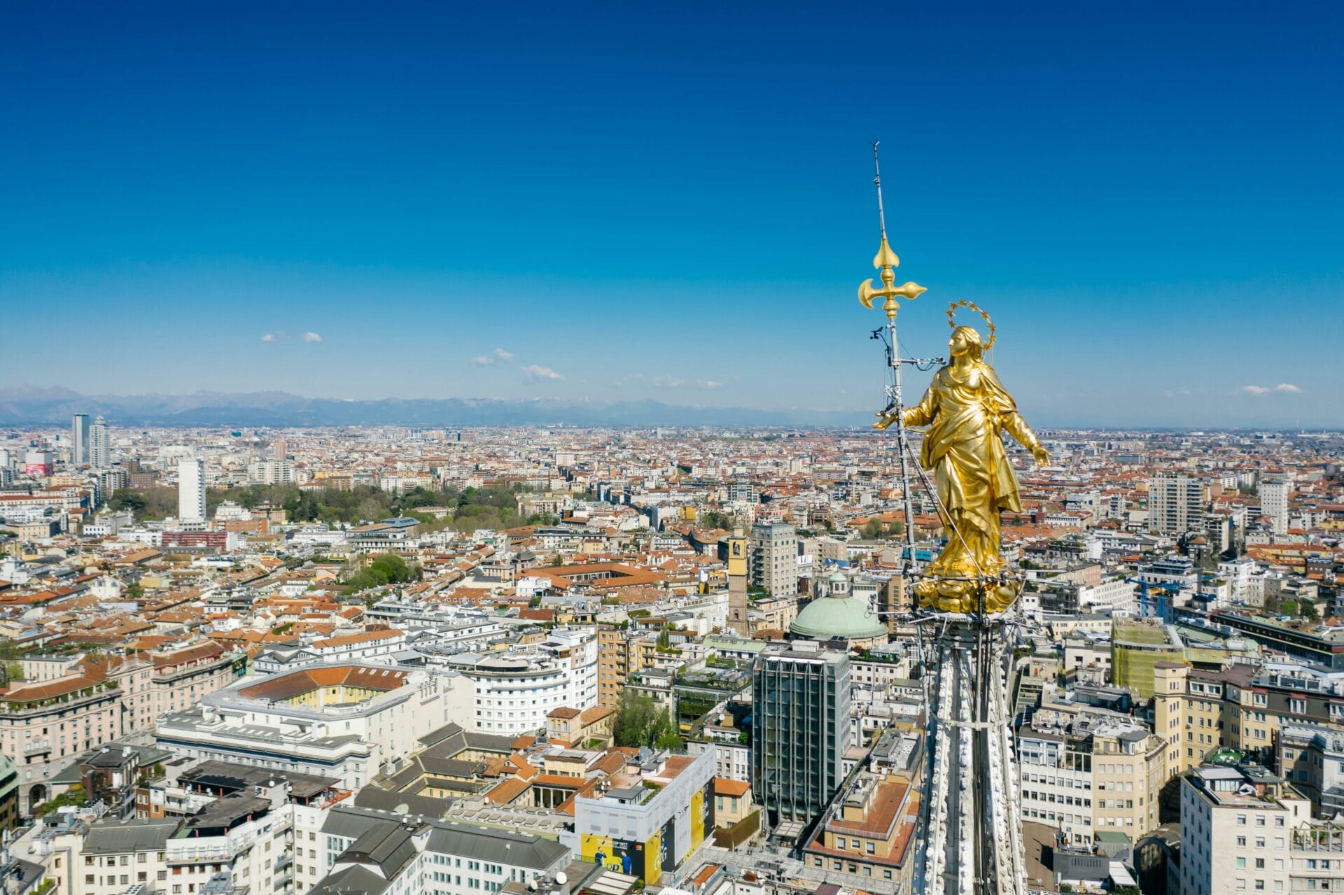 Aerial View of City of Milan with Golden Statue on Top of a Building. Italy.