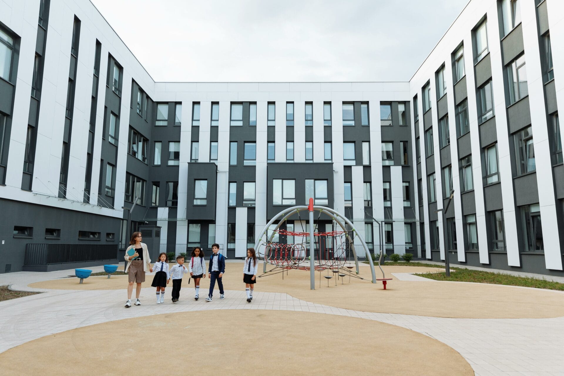 Teacher and Students Walking Around the School Campus. Photo by Thirdman via Pexels.