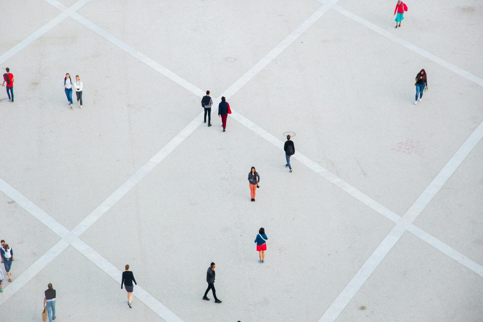 People walking on spacious concrete square. Lisbon, Portugal.