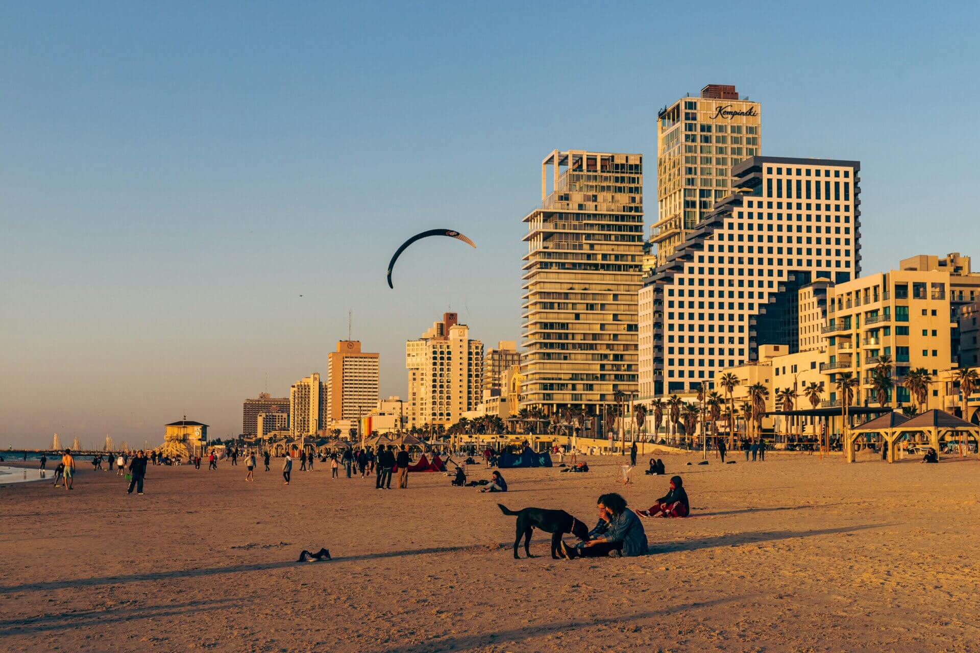 People on the beach in front of buildings. Tel Aviv, Israel - city in the sun