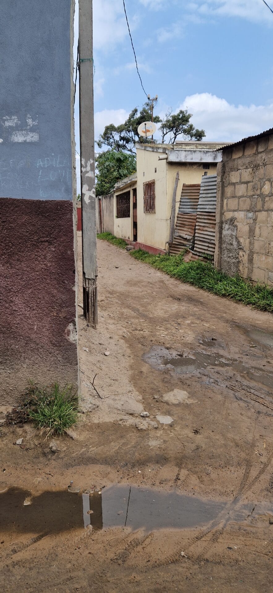 Muddy street between buildings